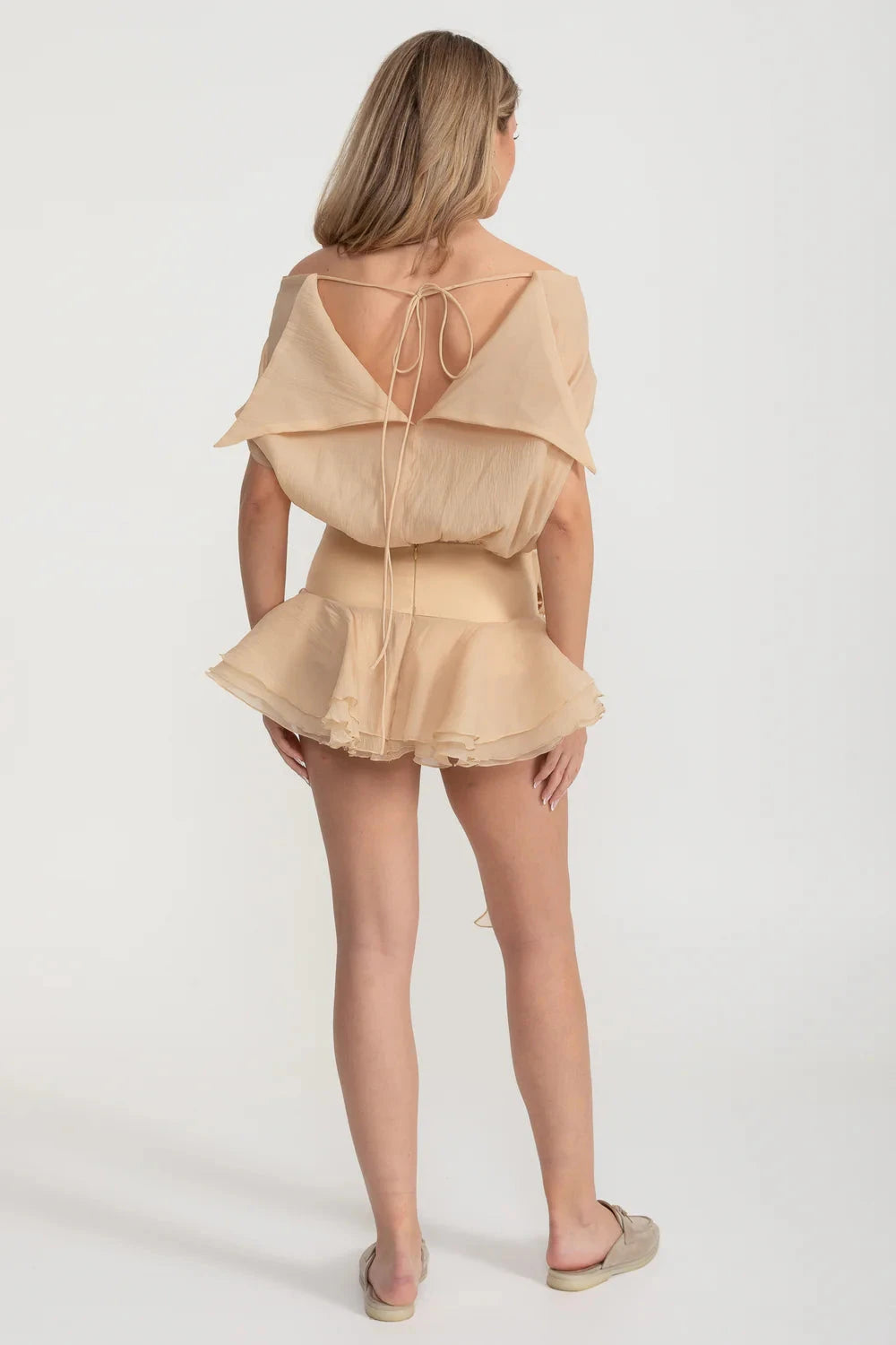 Elegant Mini Dress With Peplum Hem And Rosette Waist Embellishment - Beige
